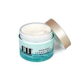 A light blue jar of the Emma Hardie Moringa Luxury Body Butter. 