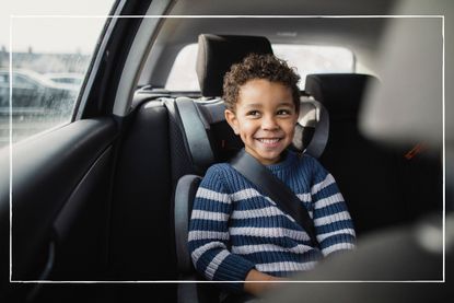 young boy in car seat wearing seatbelt