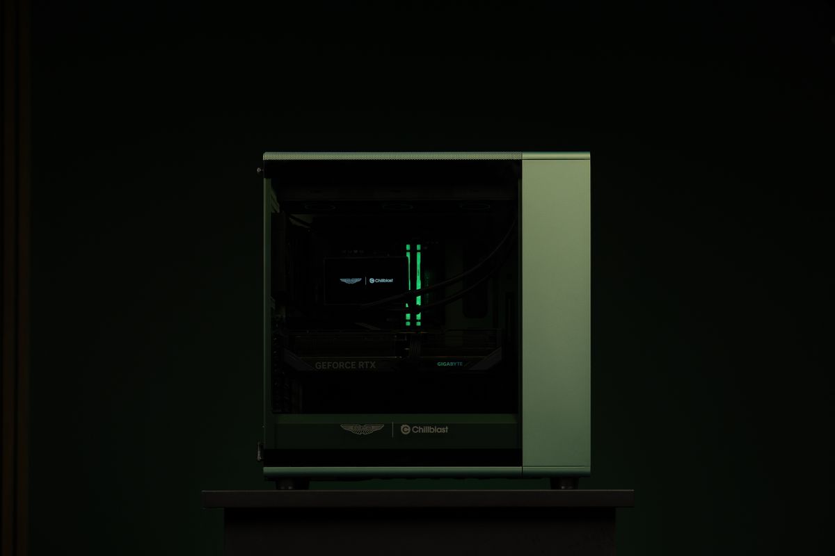 A PC gaming rig designed by Aston Martin, green with wood pannelling