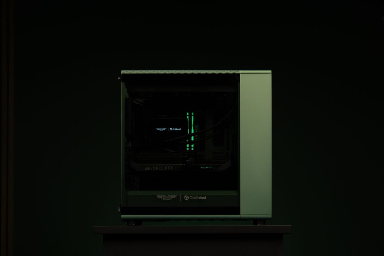 A PC gaming rig designed by Aston Martin, green with wood pannelling