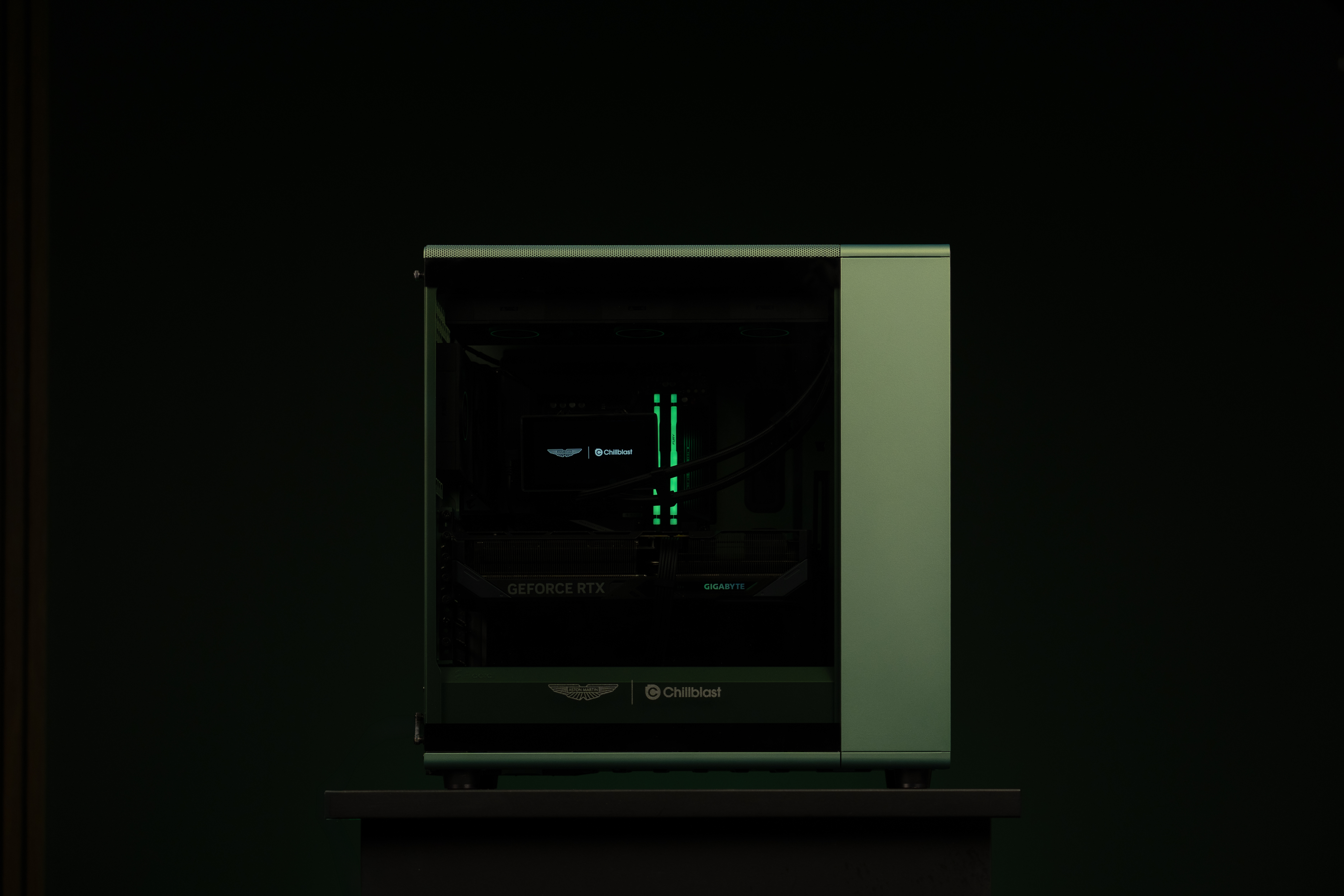 A PC gaming rig designed by Aston Martin, green with wood pannelling