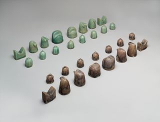 This Iranian chess set, created in the 12th century, features four stone rooks with two pointed horns each, representing horse-drawn chariots. The design is nearly identical to the "rook" figurine discovered at Humayma.