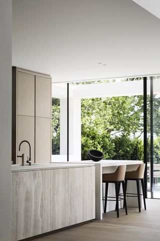 Oak kitchen with white island and stools