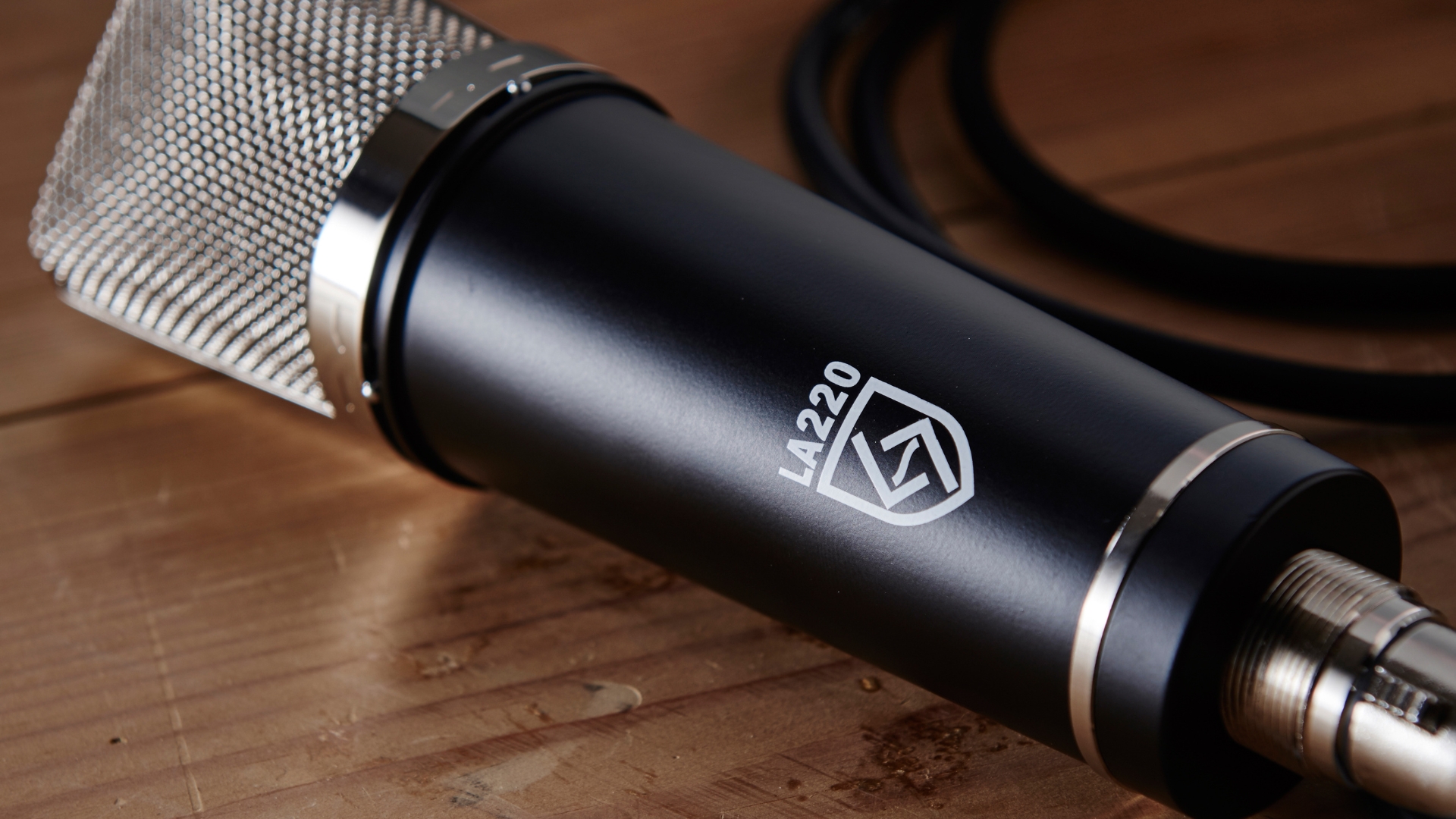 A Lauten condenser microphone lying on a wooden floor