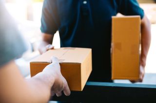 A person being handed a parcel.