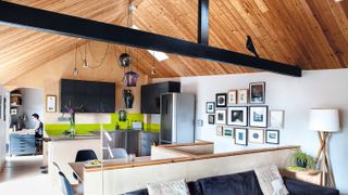 vaulted timber clad ceiling with black beams