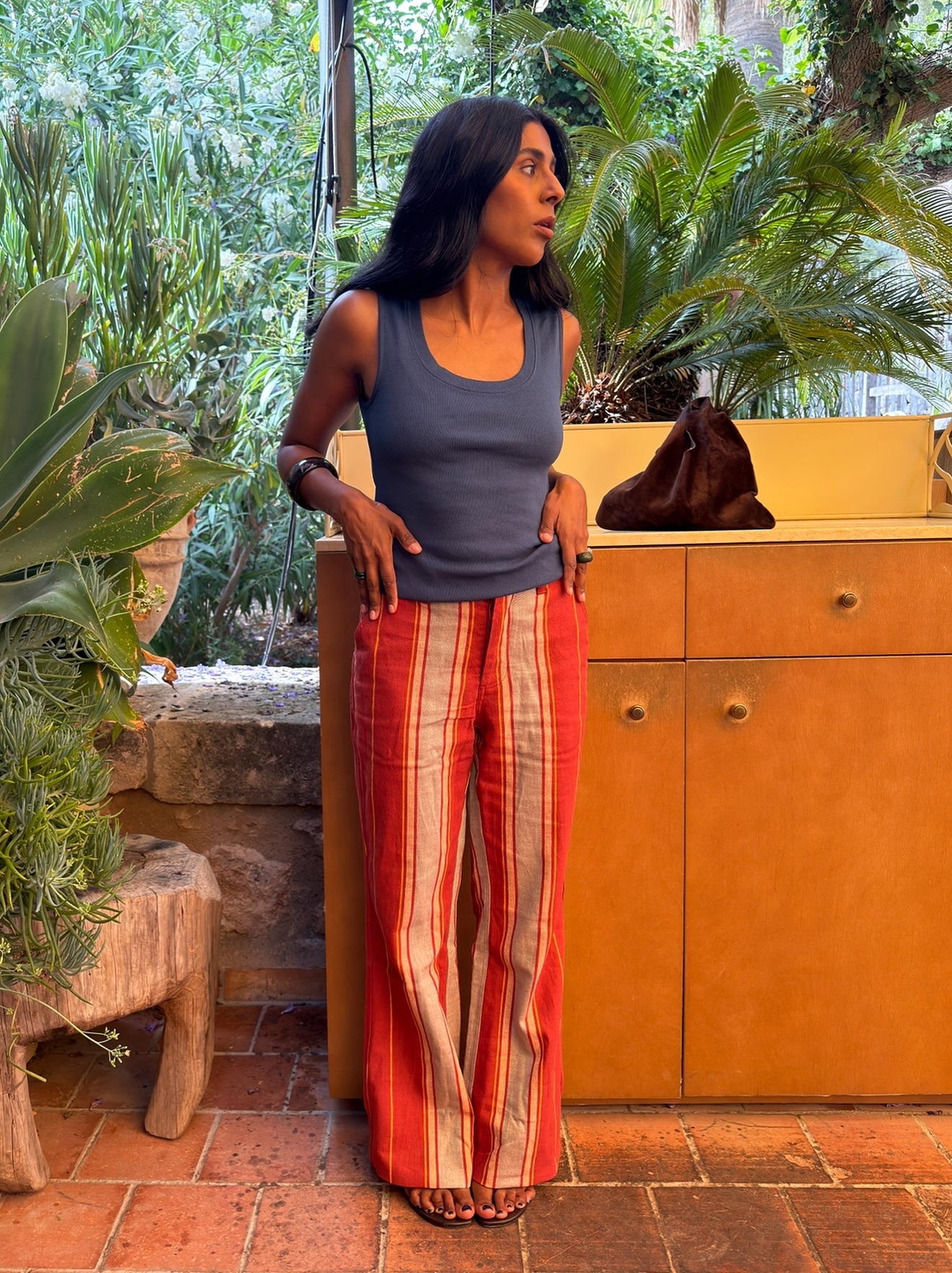 Woman in striped pants and a tank top.