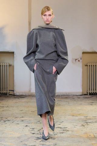 Carven model walking the fall/winter 2024 runway wearing a high roll-neck top.