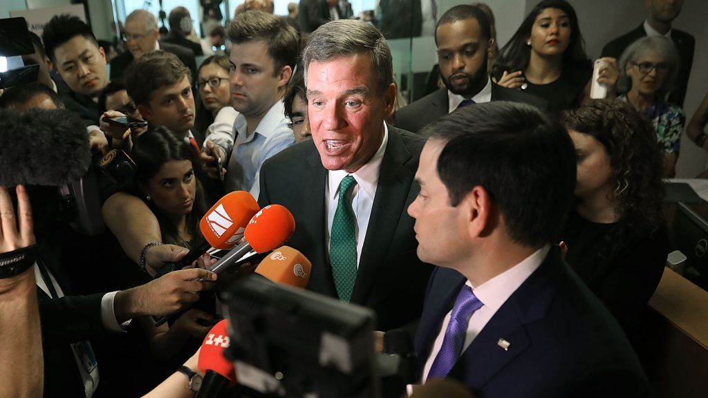 Sen. Mark Warner (D-VA) (L) and Sen. Marco Rubio (R-FL), vice chair and chair of the Senate Intelligence Committee, are pictured speaking to the press in 2018.