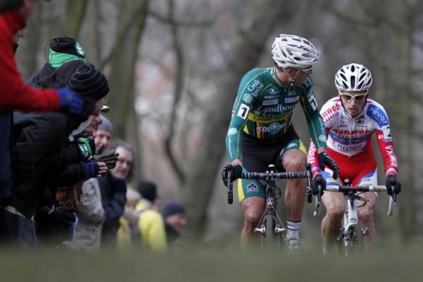 Race leader Sven Nys checks on rival Kevin Pauwels.