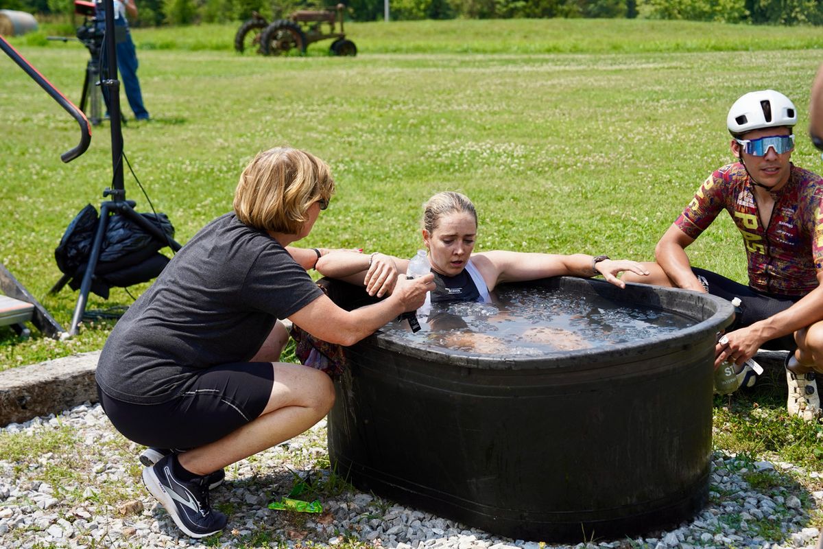 Raylyn Nuss cools off in an ice bath after crossing the line, accompanied by her teammate Curtis White, 4th place overall in the men&rsquo;s field.