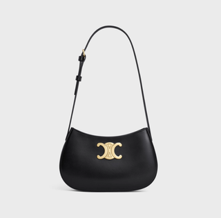 a black Celine Tilly bag in front of a plain backdrop