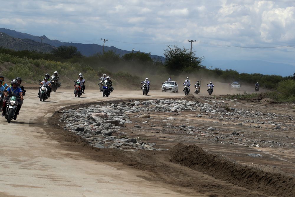 A line of motos approached the high water during stage 4 in San Juan