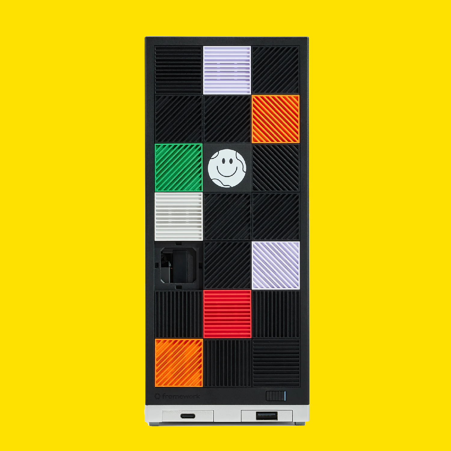 A Framework Desktop mini PC on a yellow background.