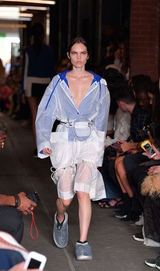 Model wearing raincoat on a catwalk