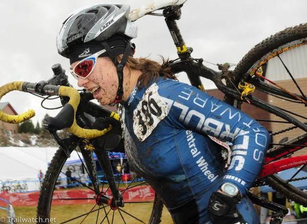 Rebecca Blatt (Central Wheel) shouldering her bike on the steps