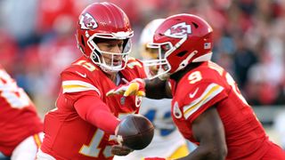 Kansas City Chiefs quarterback Patrick Mahomes handing the ball off to running back Kenneth Walker