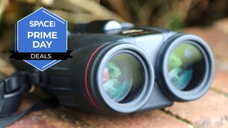 The Canon 10x42 L IS WP binoculars on a brick wall with a blue Space.com Prime Day badge in the upper left corner.