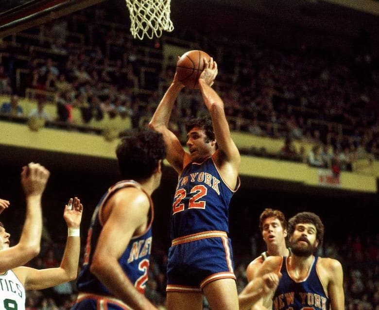 Dave DeBusschere rebounds against the Celtics.