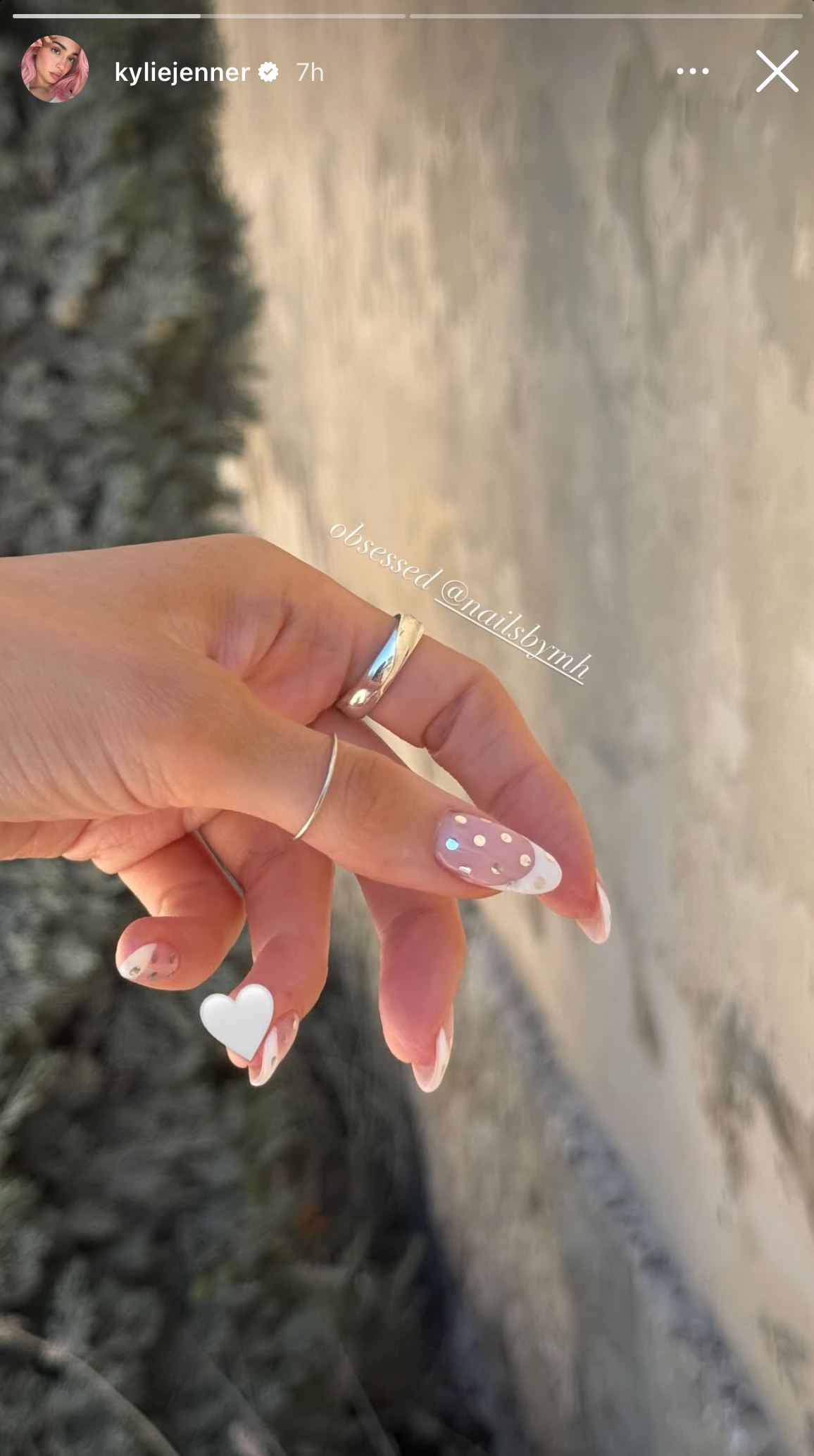 a french manicure with rhinestones