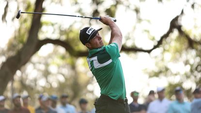 Viktor Hovland hits a fairway wood at the Players Championship