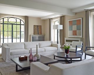 Living room with white sofas and cream walls