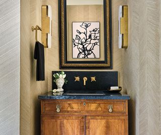 powder room with black and gold furnishings and walnut-style vanity cabinet