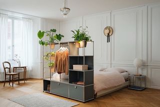 Studio apartment with bed and potted plants