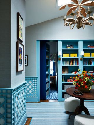 eclectic blue hallway with hidden door in the bookcase