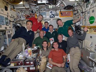 Inside the Zvezda service module on the International Space Station, space shuttle Atlantis and station crew members take a break from an extremely busy work agenda for photos and a social period. Not much time remains for such reunions, as undocking and separation activities are scheduled for a little over 48 hours from the time this photo was made on July 16, 2011, Flight Day 9. The STS-135 crew consists of Commander Chris Ferguson, Pilot Doug Hurley, Mission Specialists Sandy Magnus and Rex Walheim; the Expedition 28 or station crew members are JAXA astronaut Satoshi Furukawa, NASA astronauts Ron Garan and Mike Fossum, and Russian cosmonauts Andrey Borisenko, Alexander Samokutyaev and Sergei Volkov.