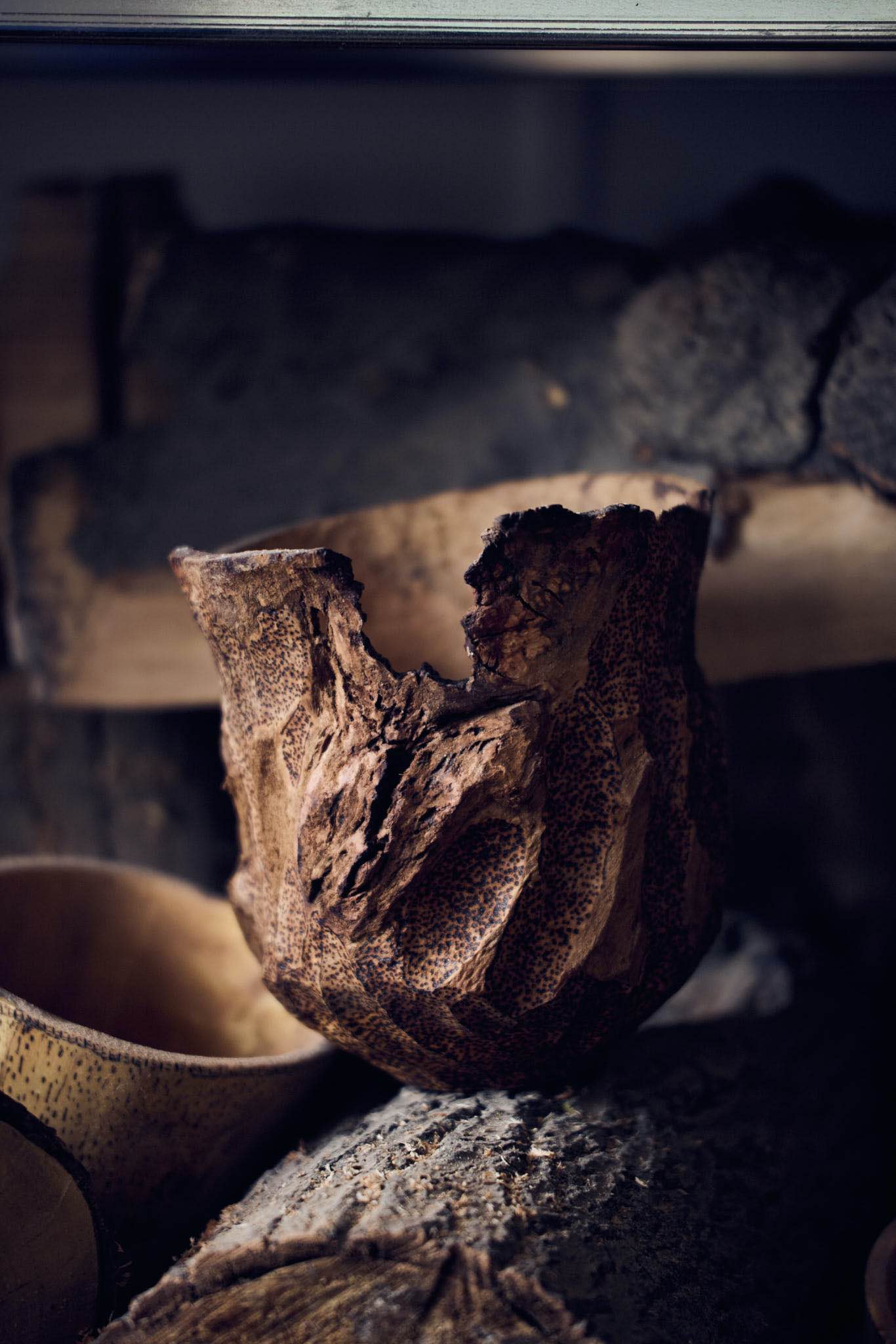 wooden vessel with rough, pokered surface