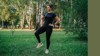 Woman doing standing ab exercises in park wearing activewear