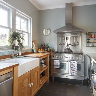 small kitchen with wood cabinets and stainless steel range oven cooker