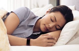 Woman asleep wearing Fitbit Charge 4