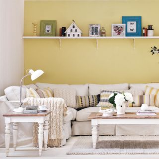Living room with yellow walls and white sofa