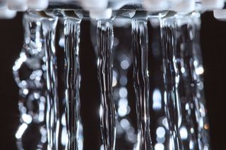 Shower head with running water.