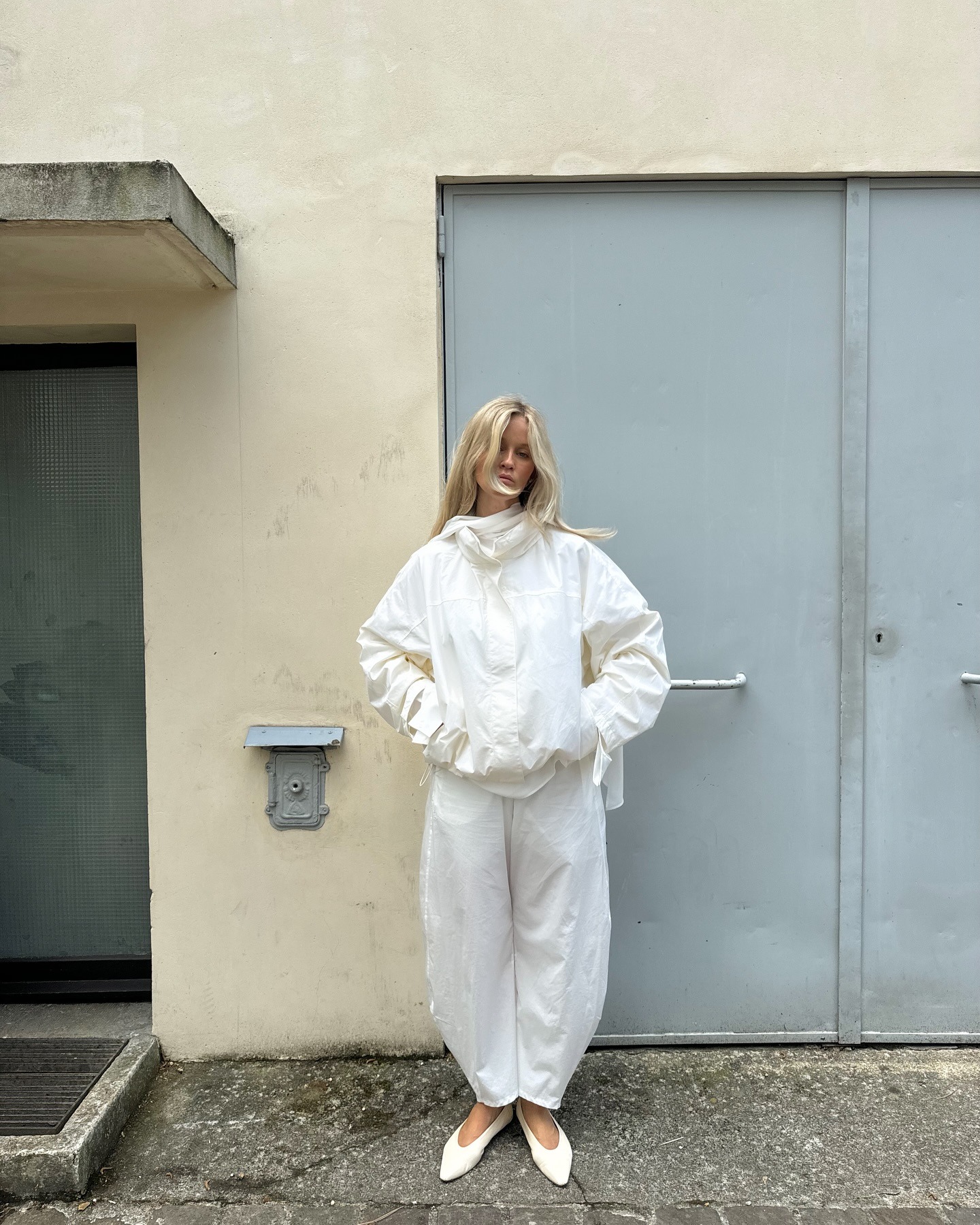 An influencer wearing a pair of almond-toe shoes.