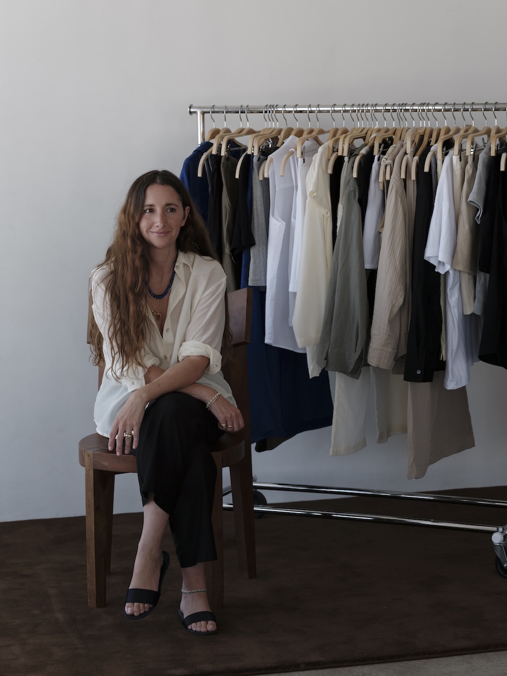 Alyssa Wasko, founder of Donni, in front of a rack of clothes