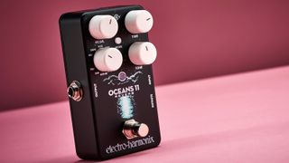 An EHX Oceans 11 reverb pedal on a pink background