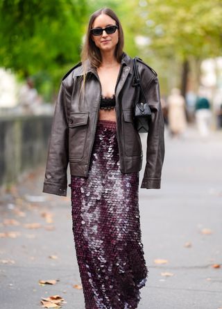 French street style - woman wearing a glitter skirt and oversized jacket