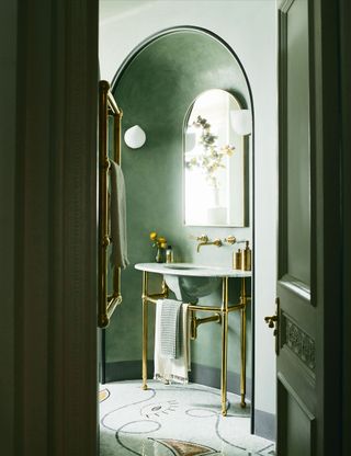 Small bathroom with arch entrance and green walls