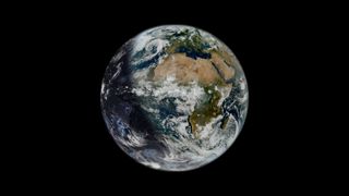 the Earth from space with a shadow on its left side. 