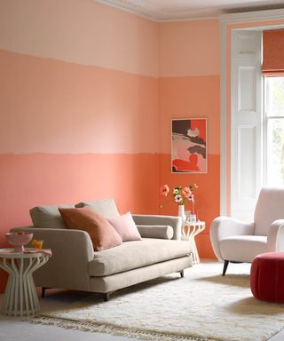 A peachy-pink living room with ombre feature wall paint decor
