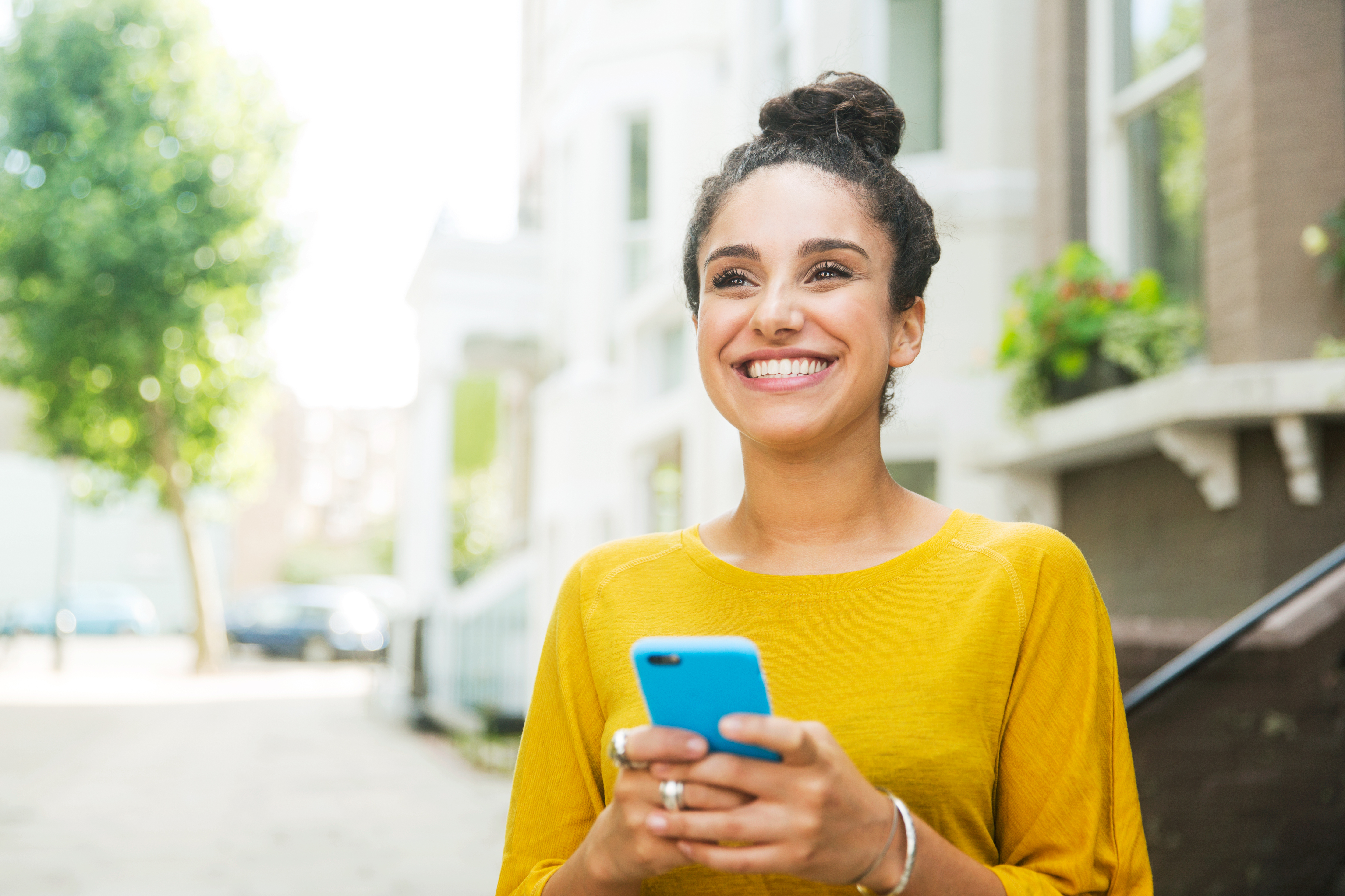 Woman smiling while holding phone