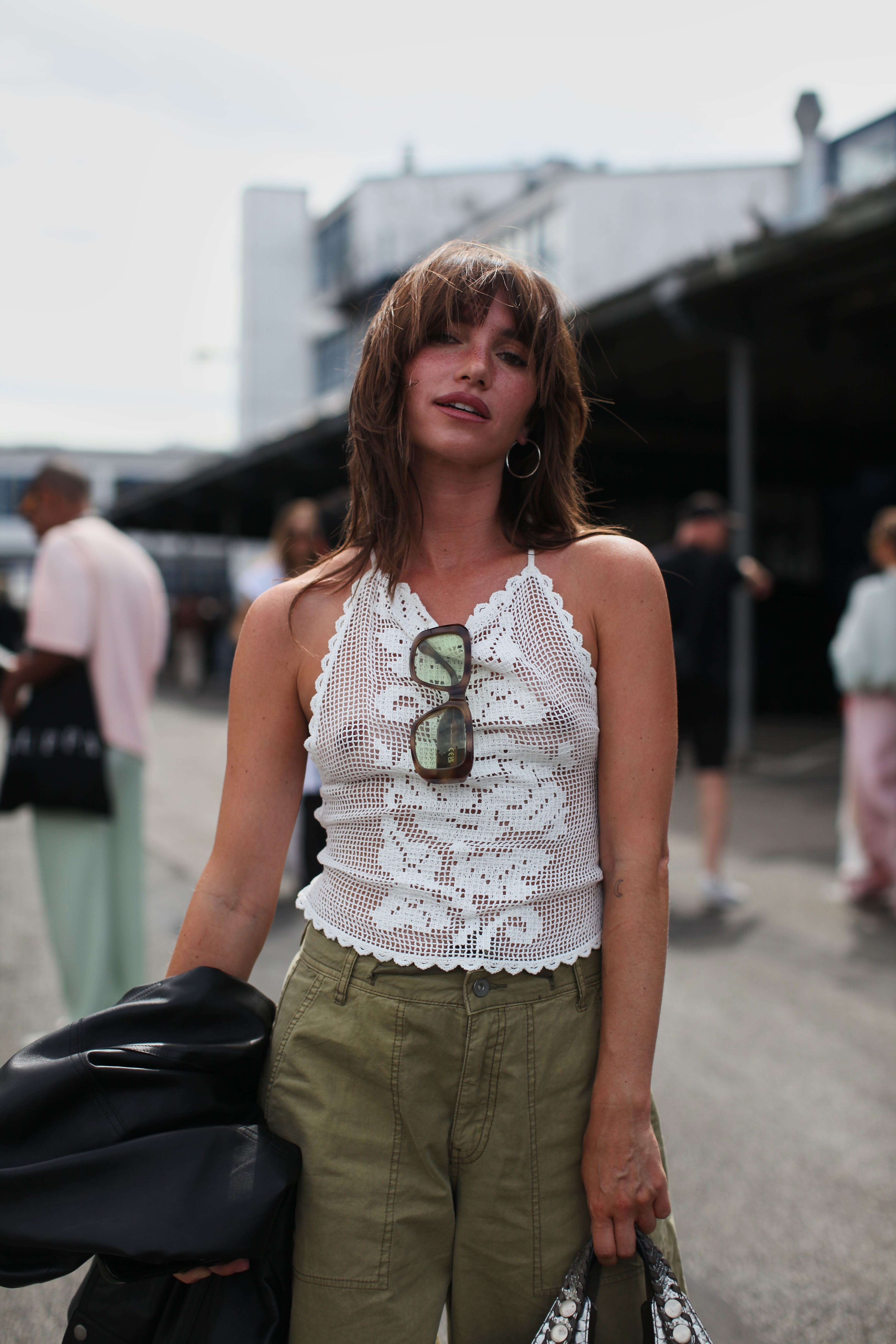 A guest wore the white lace top trend at Copenhagen Fashion Week