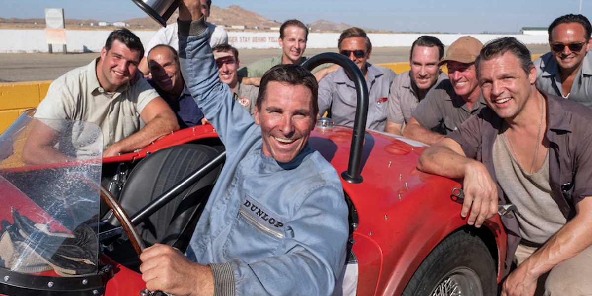 Christian Bale raising a trophy in Ford v Ferrari