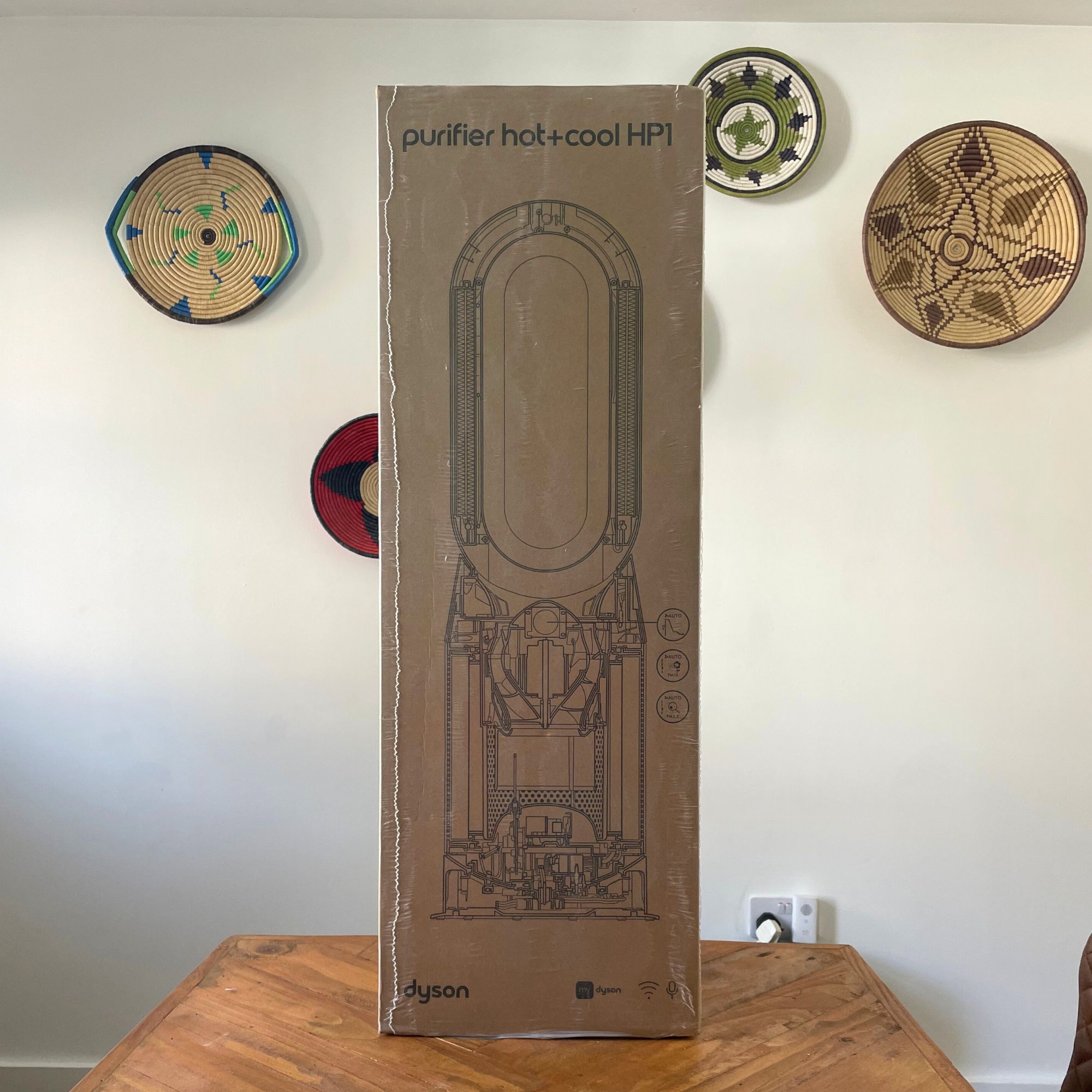 Dyson Purifier Hot+Cool HP1 Purifying Fan Heater box sitting on a wooden table in front of a white painted wall