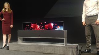 LG's rollable OLED emerging from its stand / speaker system
