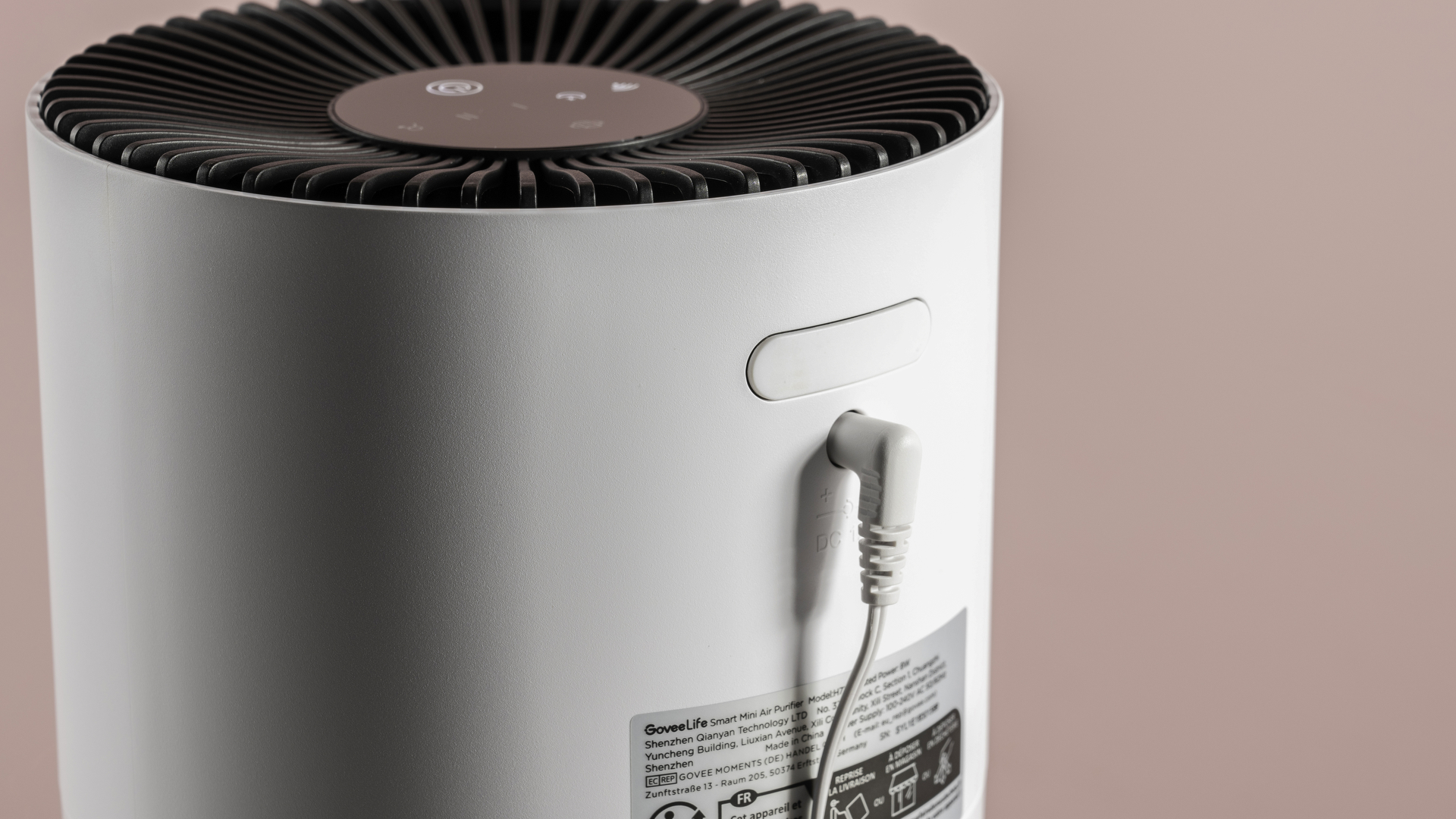 A close-up of the power cable and the closed fragrance pad tray.