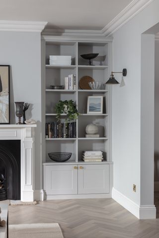 grey painted bookcase in living room alcove